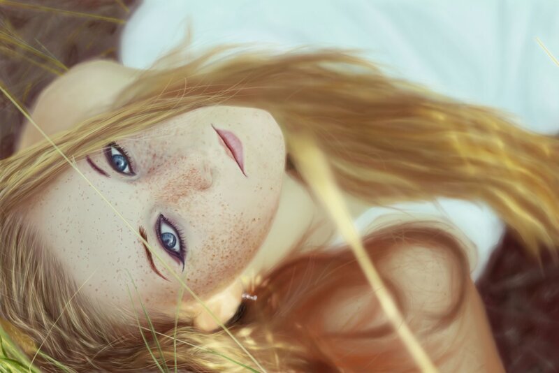 girl with freckles lying in grass