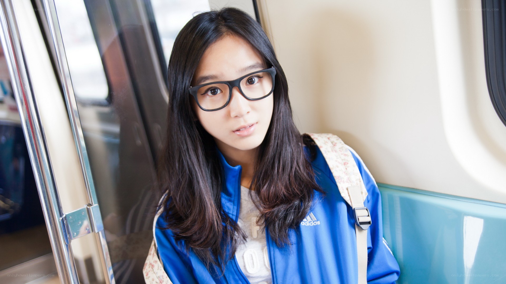 girl with glasses on a train