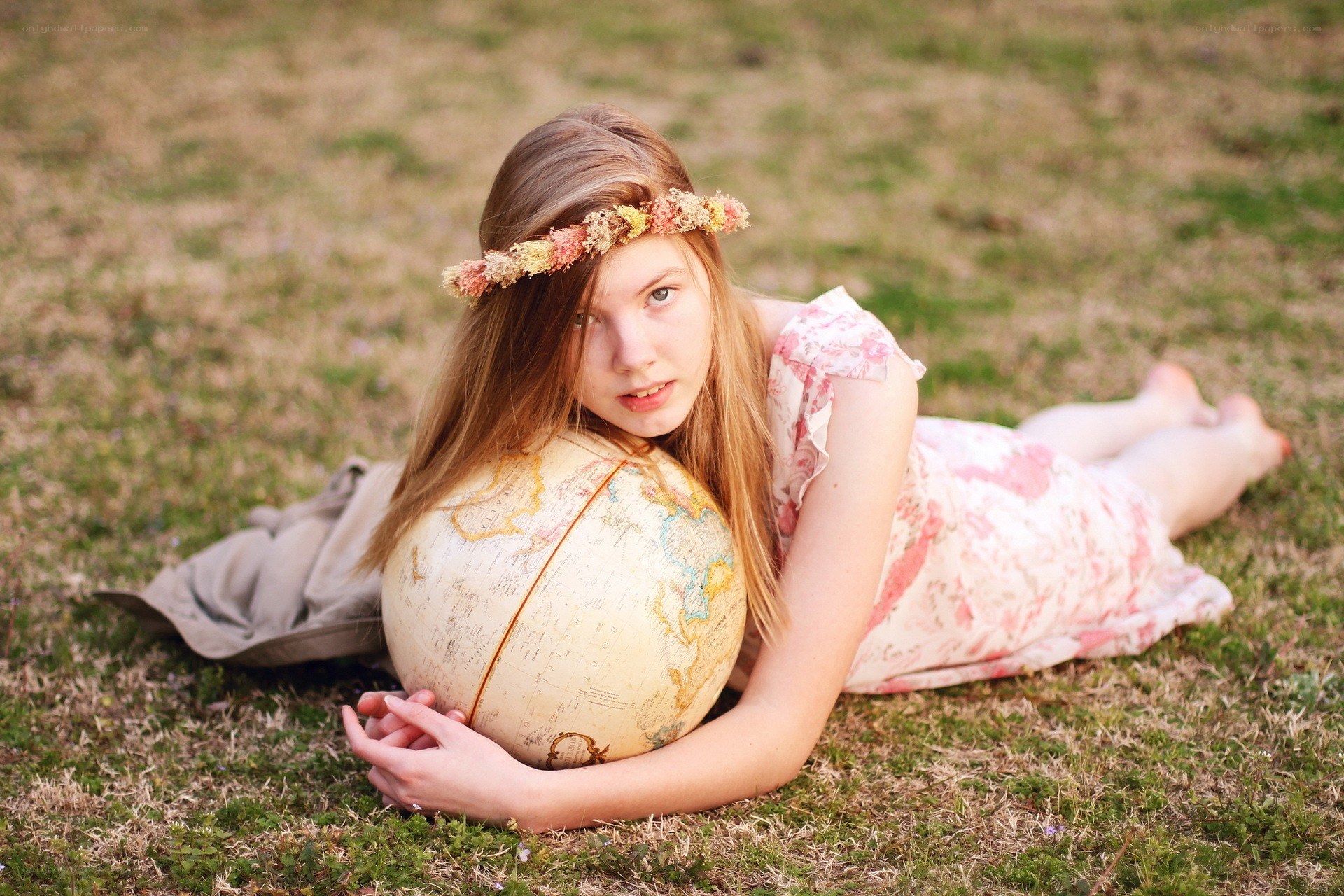 girl with globe on grass