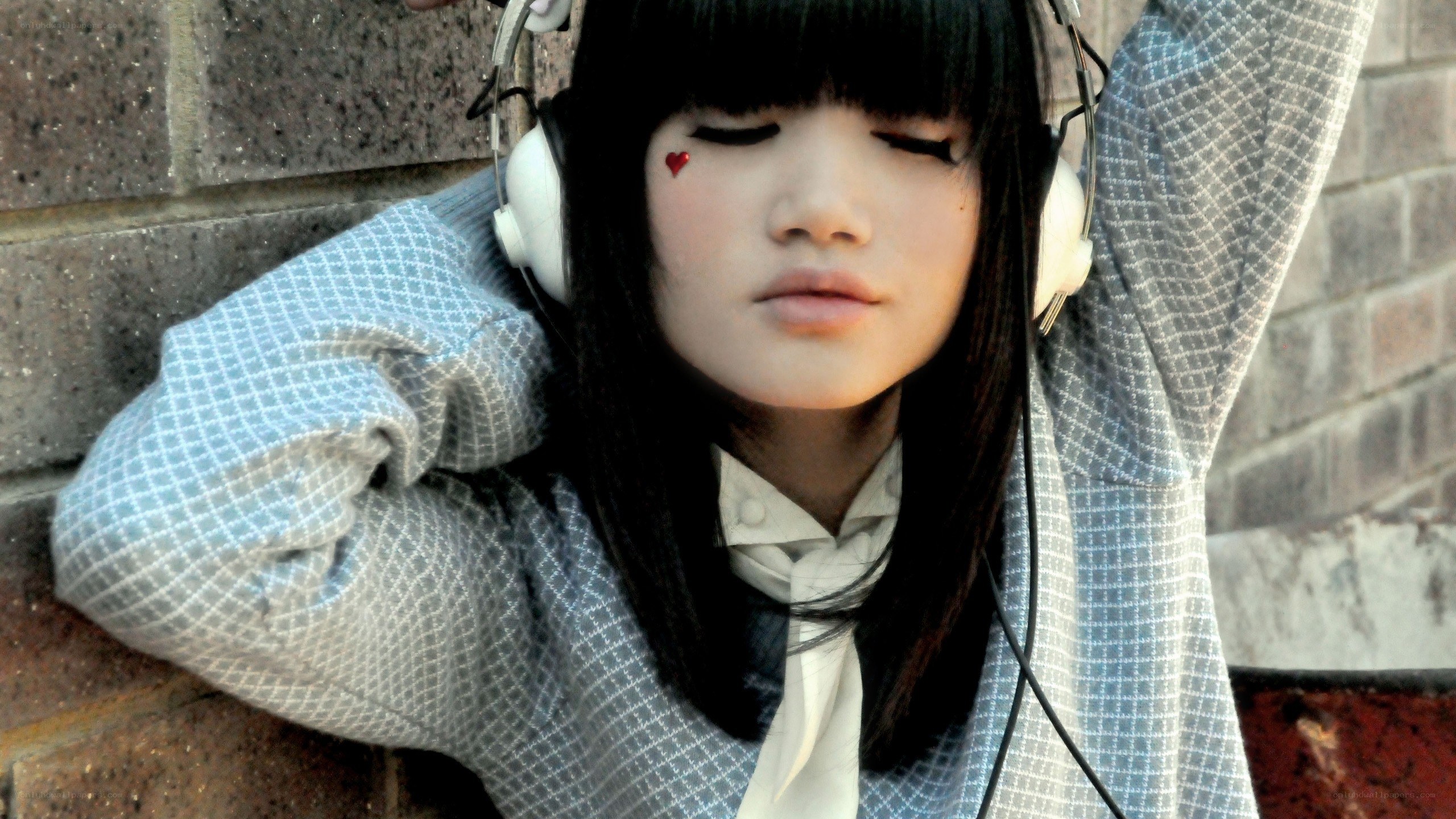 girl with headphones and heart sticker