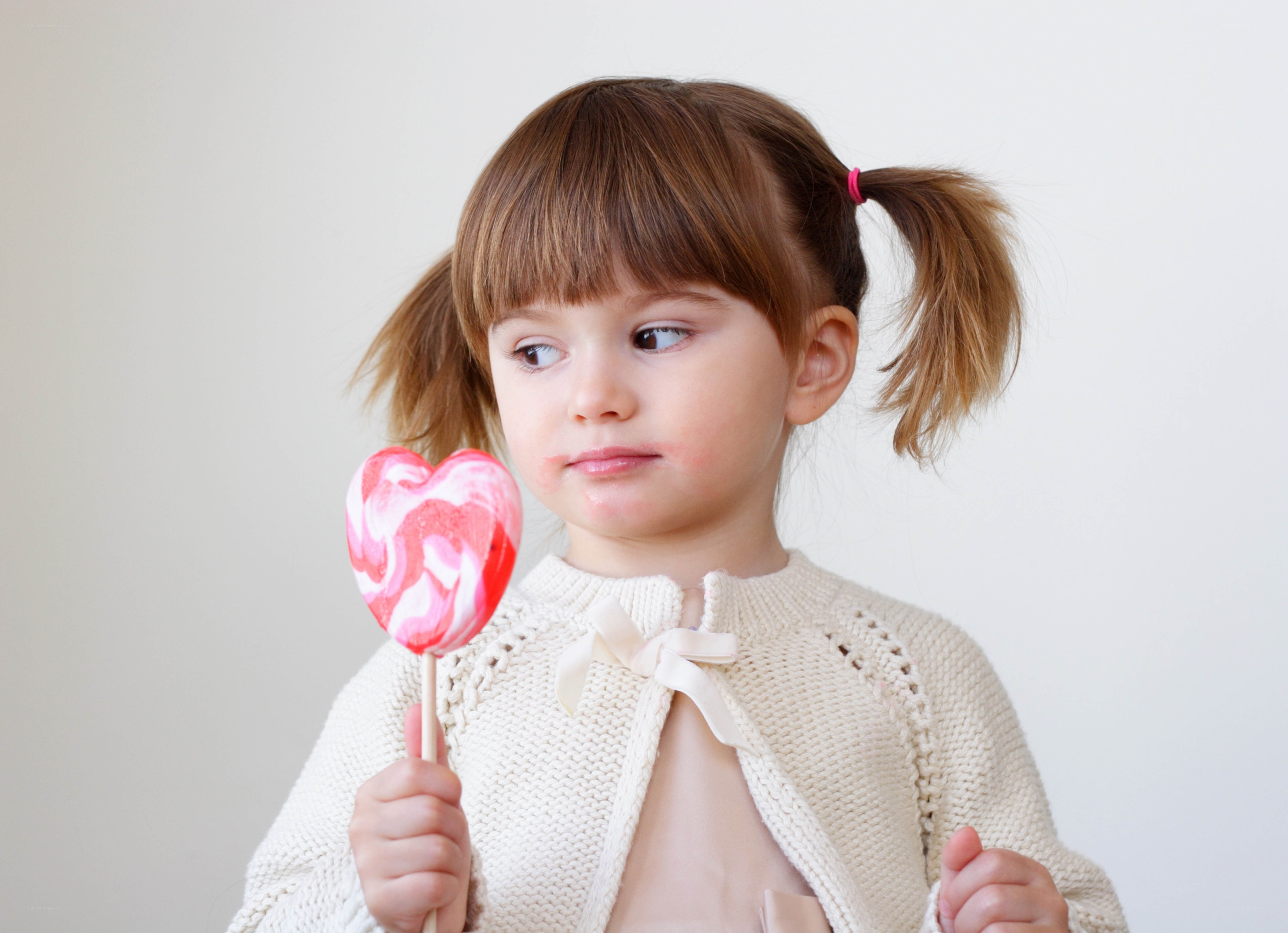 girl with heart-shaped lollipop