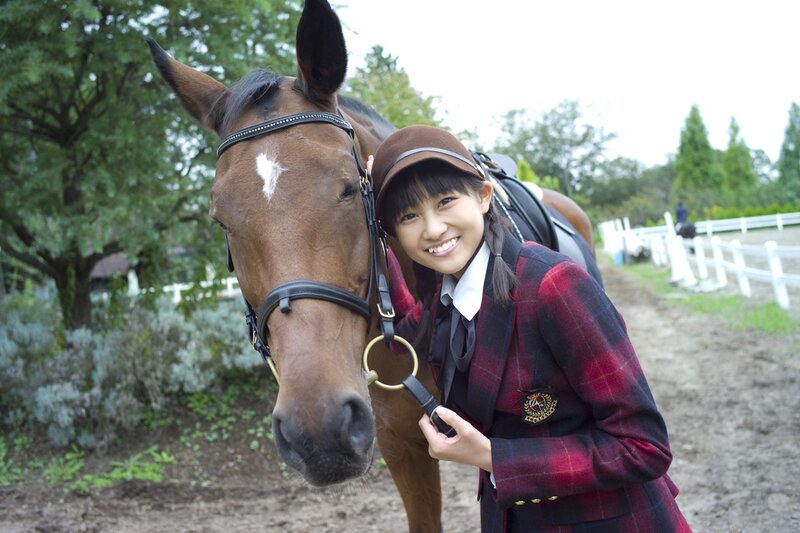 Girl with horse at equestrian center