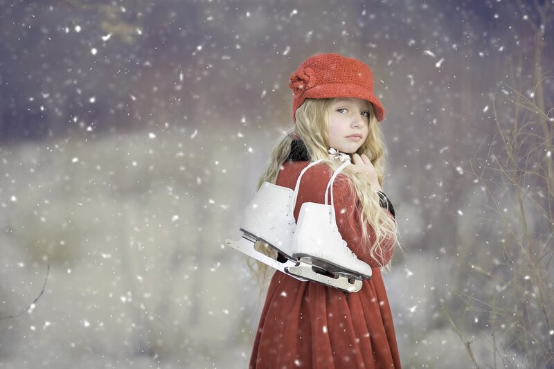 Girl with ice skates in snow