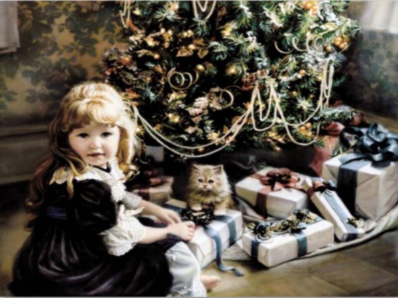 Girl with kitten by Christmas tree