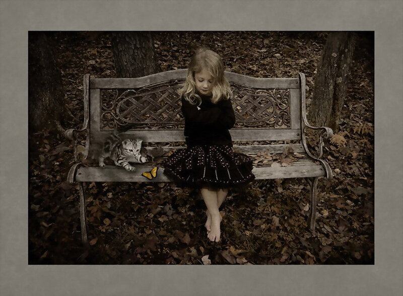 Girl with kitten on bench