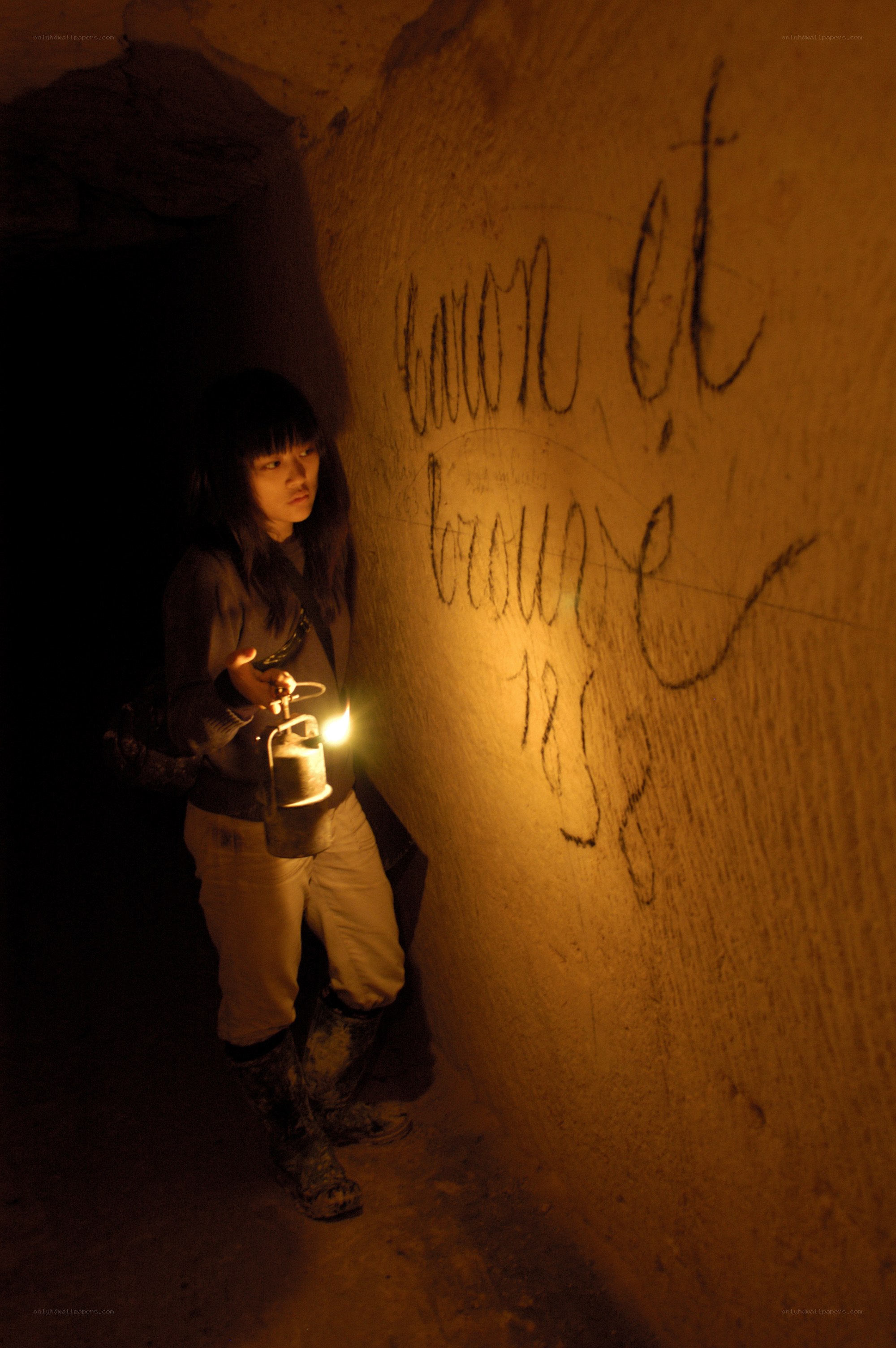 Girl with lantern in tunnel