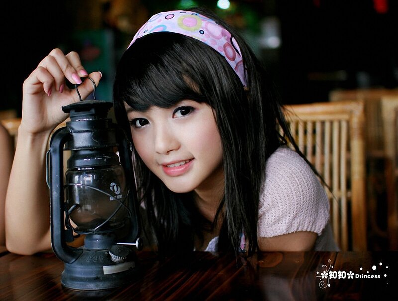 Girl with lantern on table
