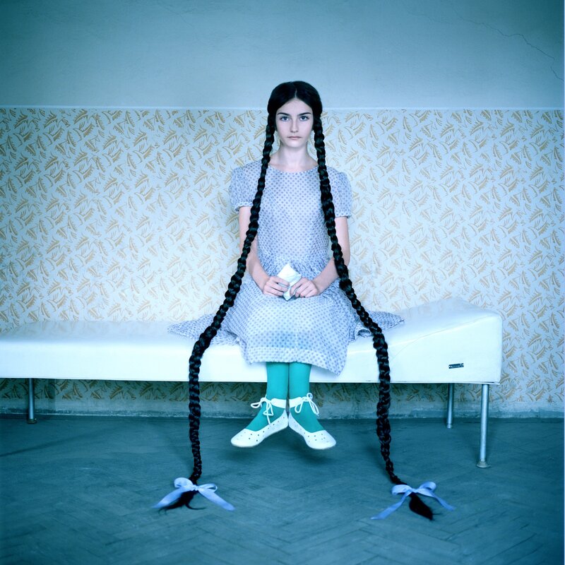 Girl with long braids sitting