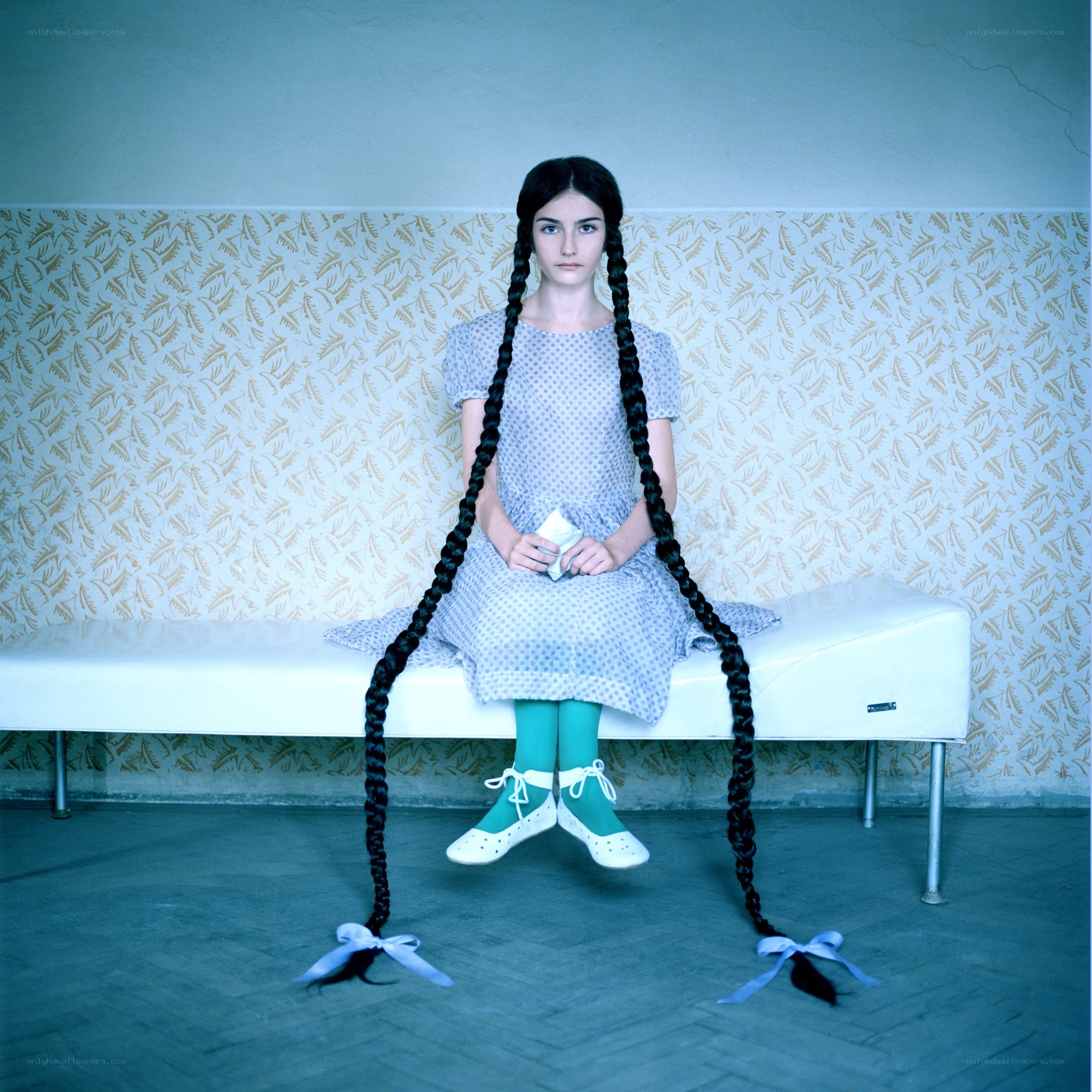 Girl with long braids sitting