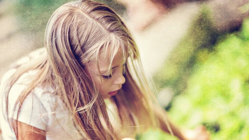 girl with long hair looking down