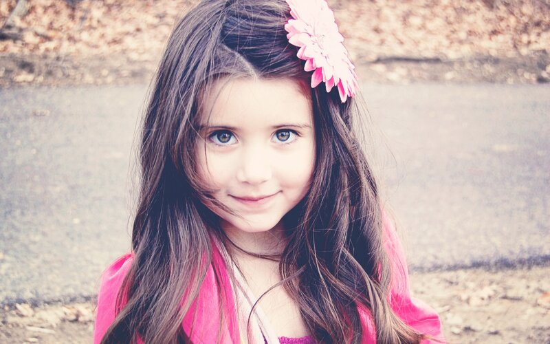 girl with pink flower in hair