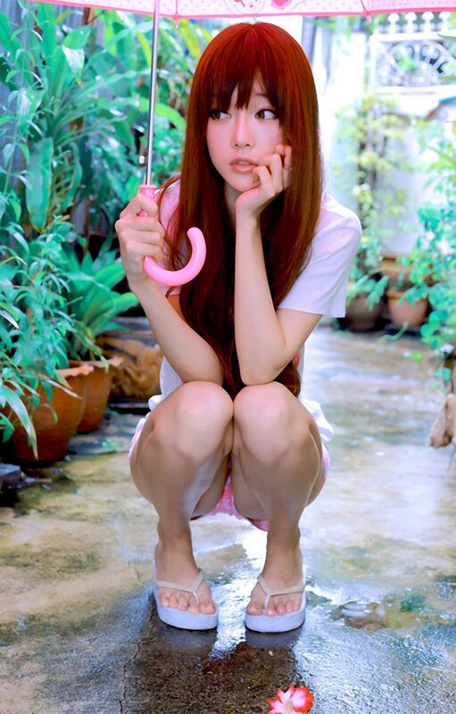 Girl with pink umbrella in rain