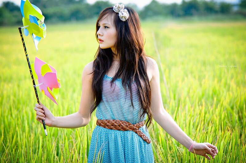 Girl with pinwheels in a field