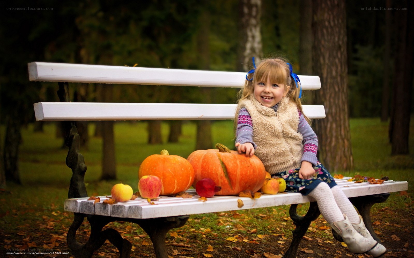 Girl with pumpkins on bench