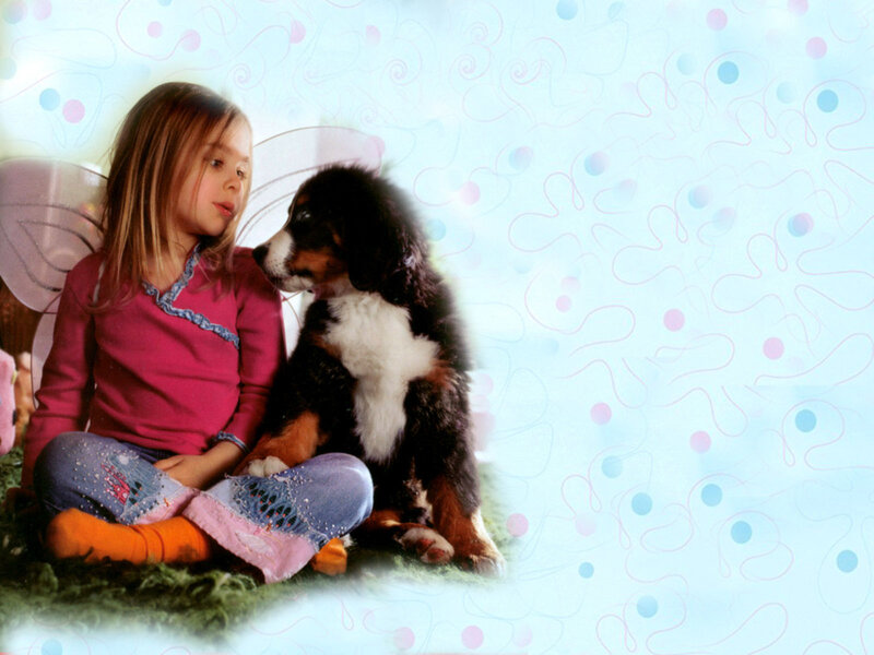 girl with puppy on grass