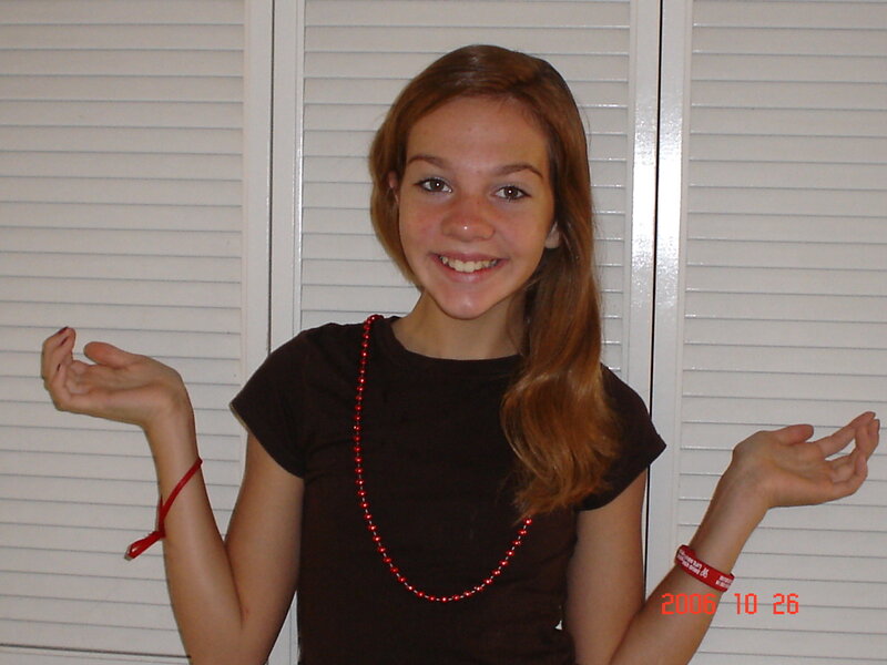 girl with red beads smiling