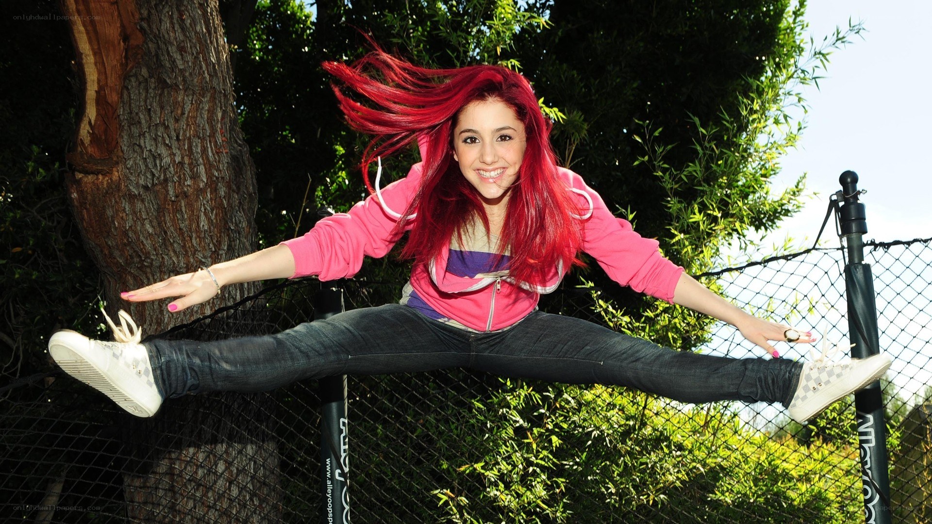 Girl with red hair doing a split