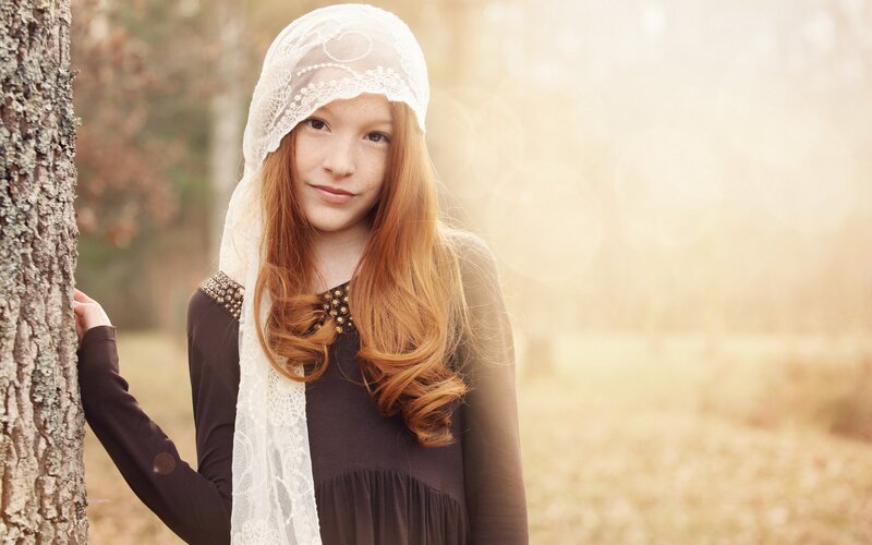 girl with red hair in forest