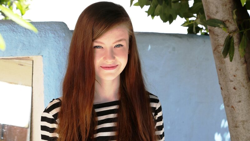girl with red hair smiling