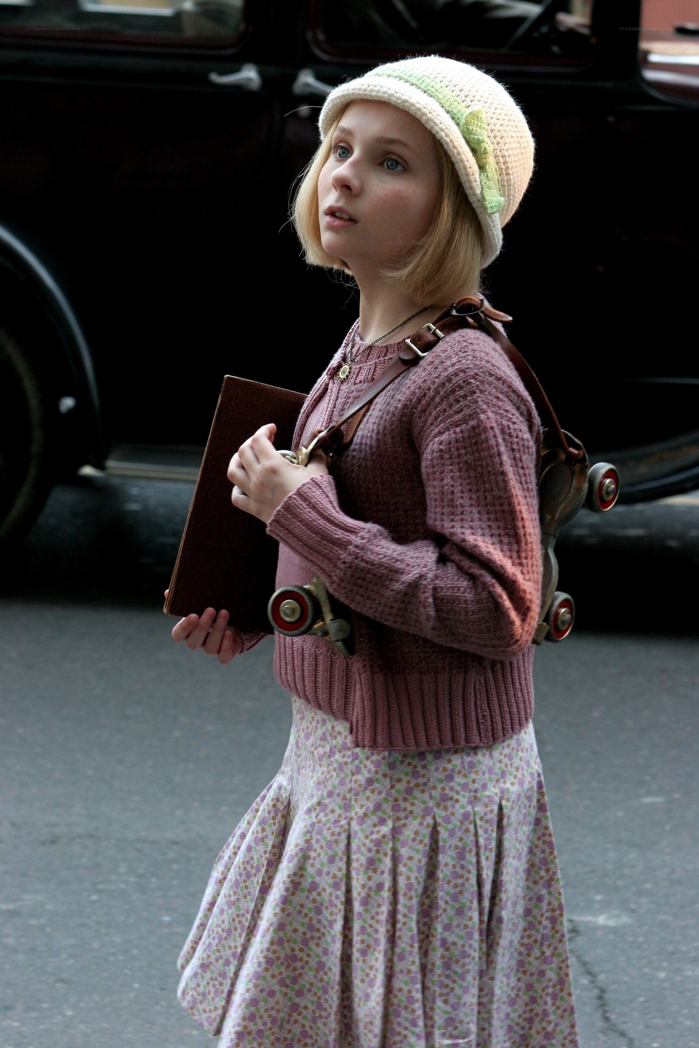Girl with roller skates and book
