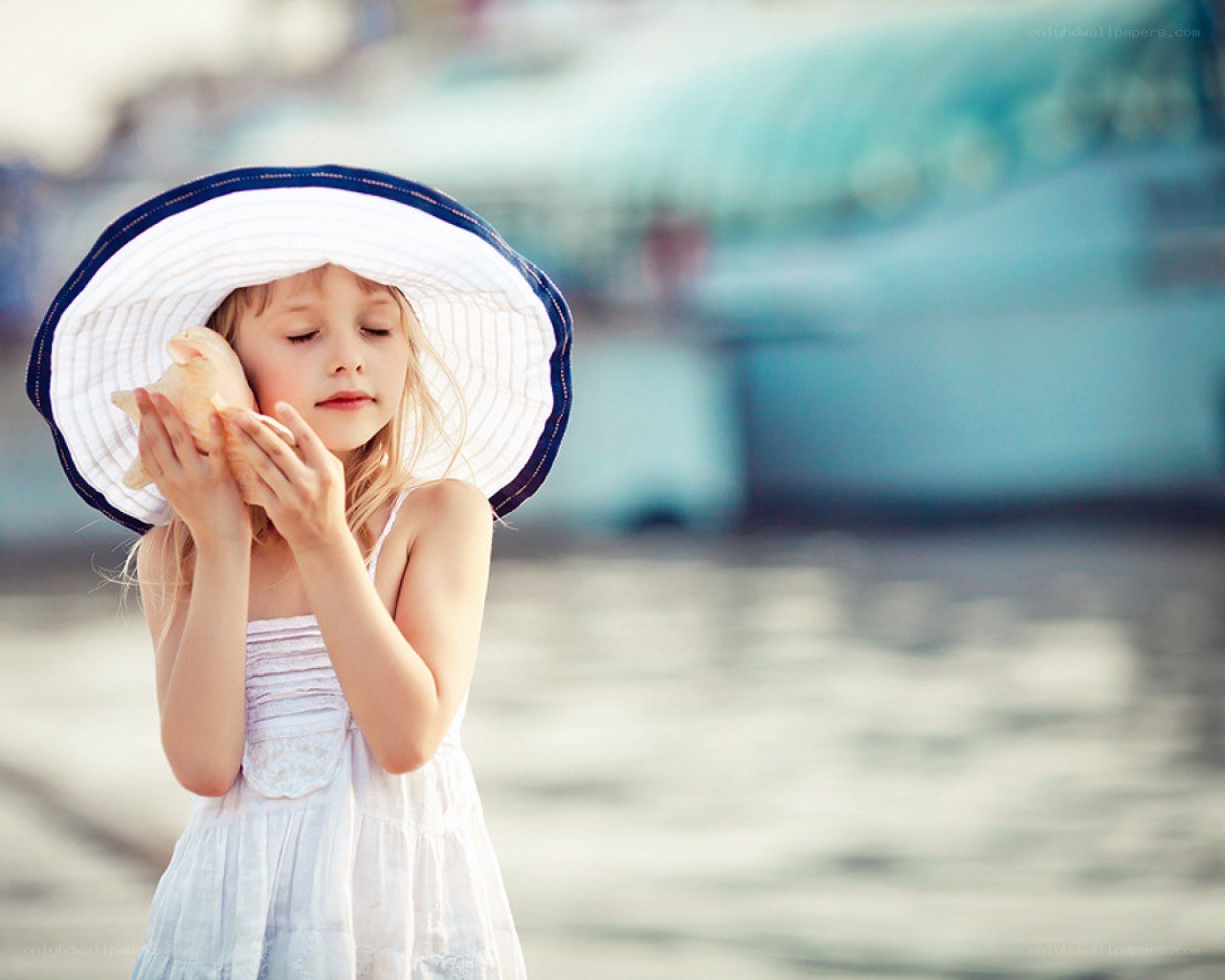 girl with seashell at beach