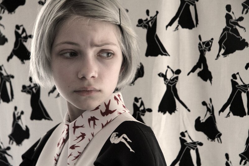 girl with short hair in patterned room