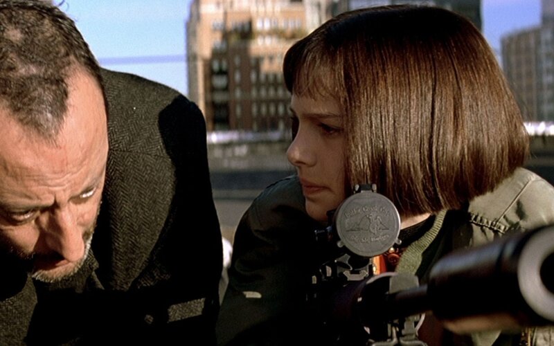 Girl with sniper rifle on rooftop