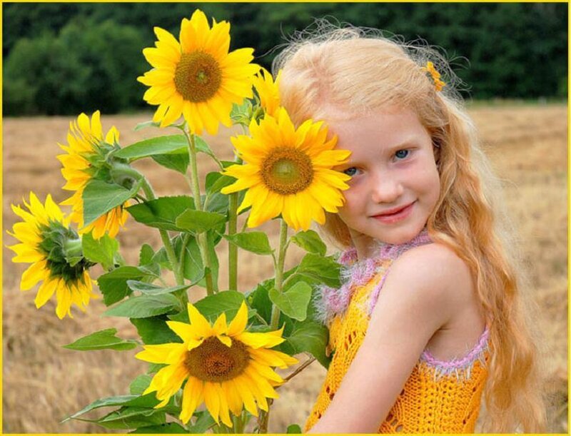 Girl with sunflowers in field