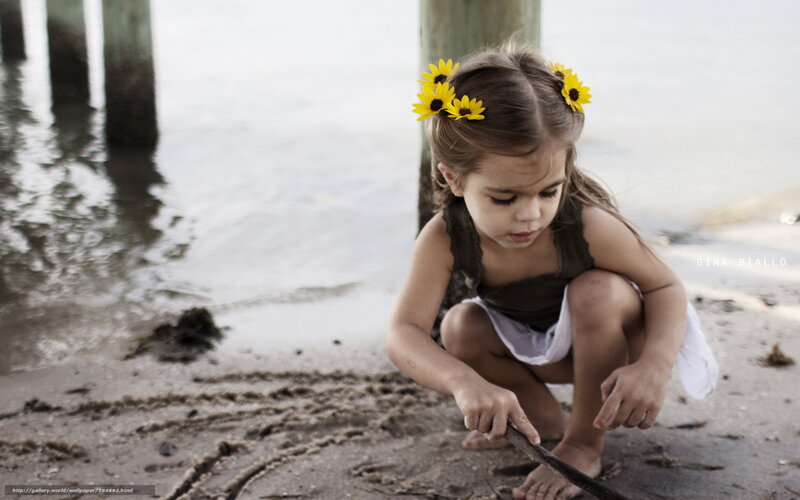 Girl with sunflowers on beach