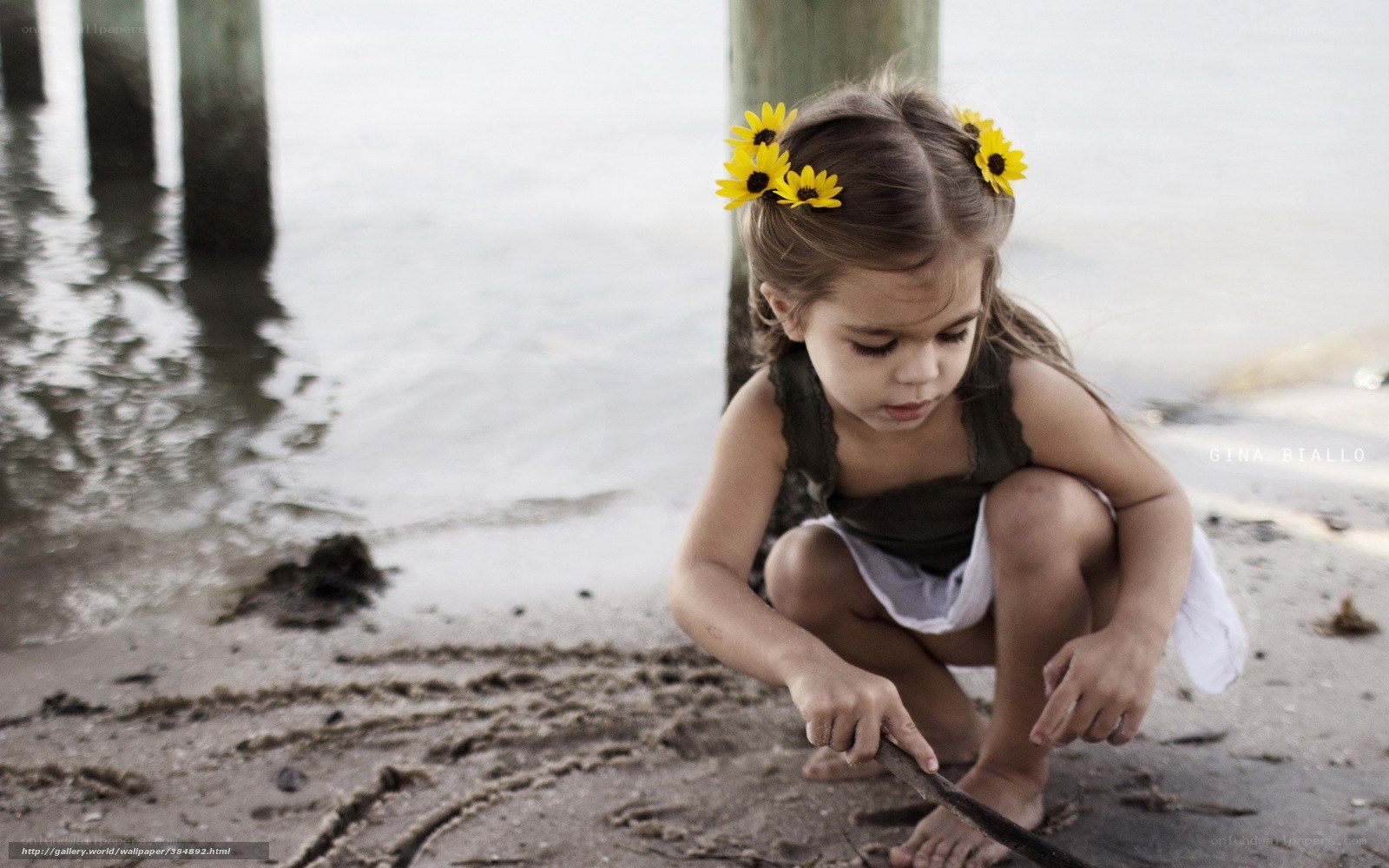 Girl with sunflowers on beach