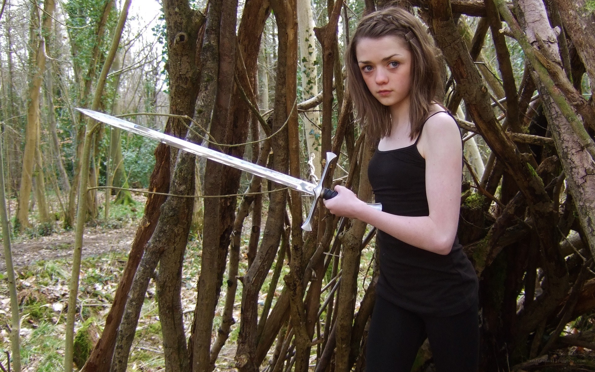 Girl with sword in forest