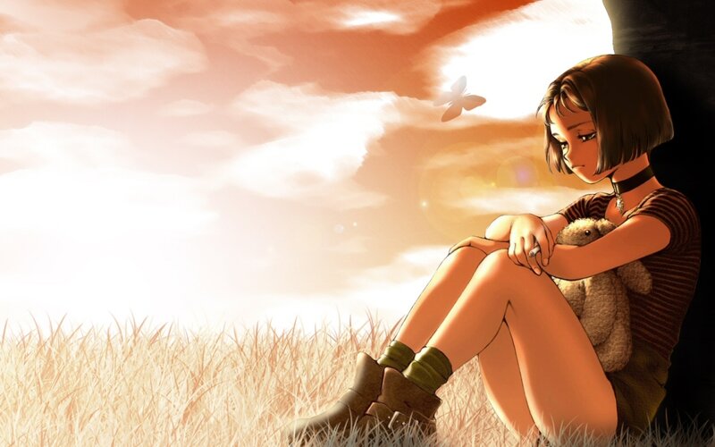 Girl with teddy bear in field