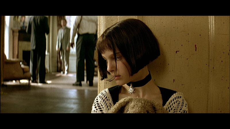 girl with teddy bear in hallway