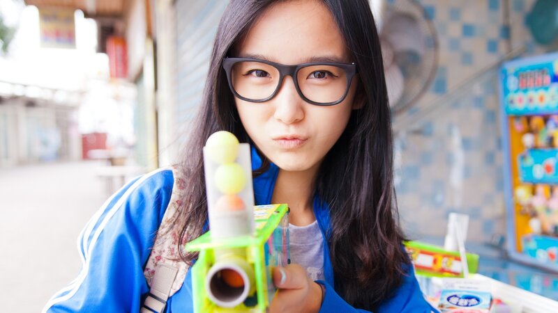 Girl with toy gun at arcade