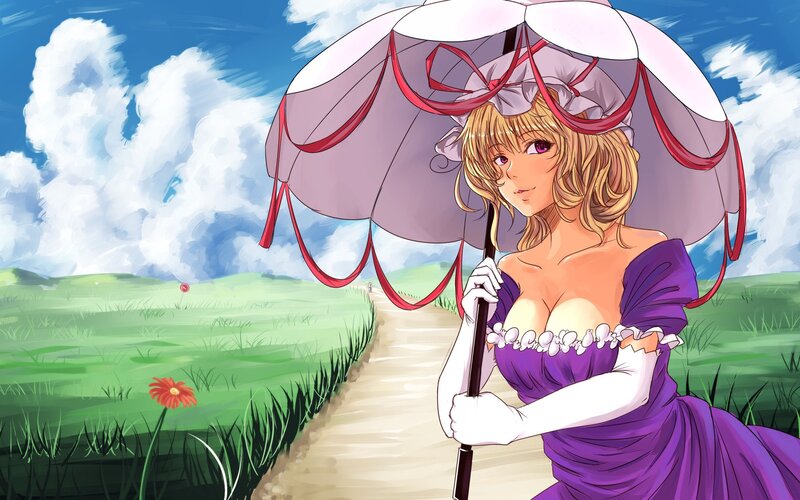 Girl with umbrella in field