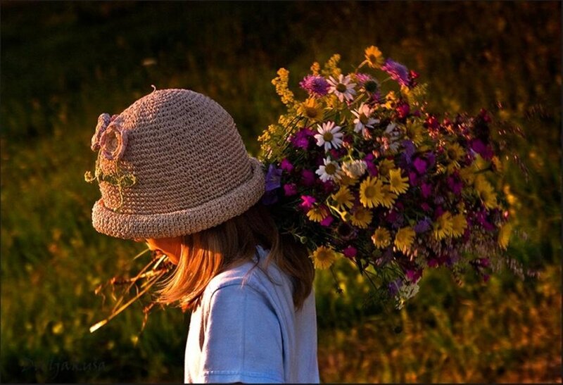 Girl with wildflowers in field