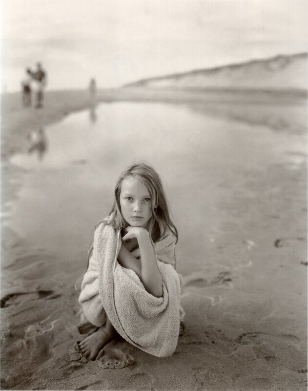 Girl wrapped in towel on beach