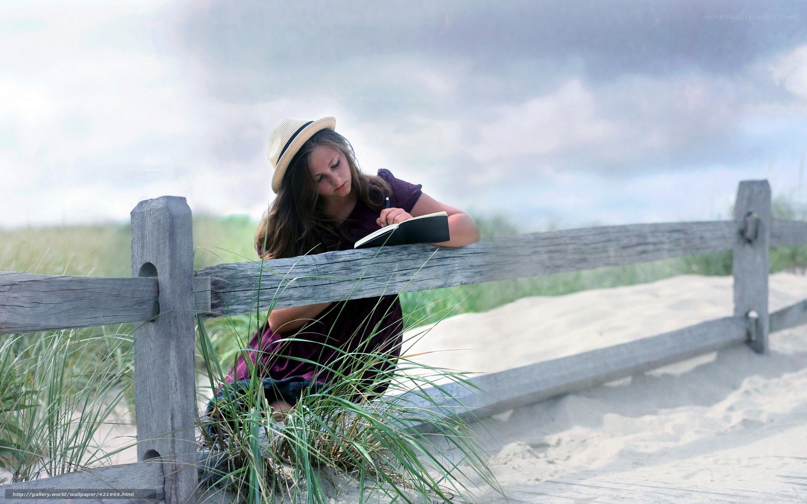 Girl writing on beach