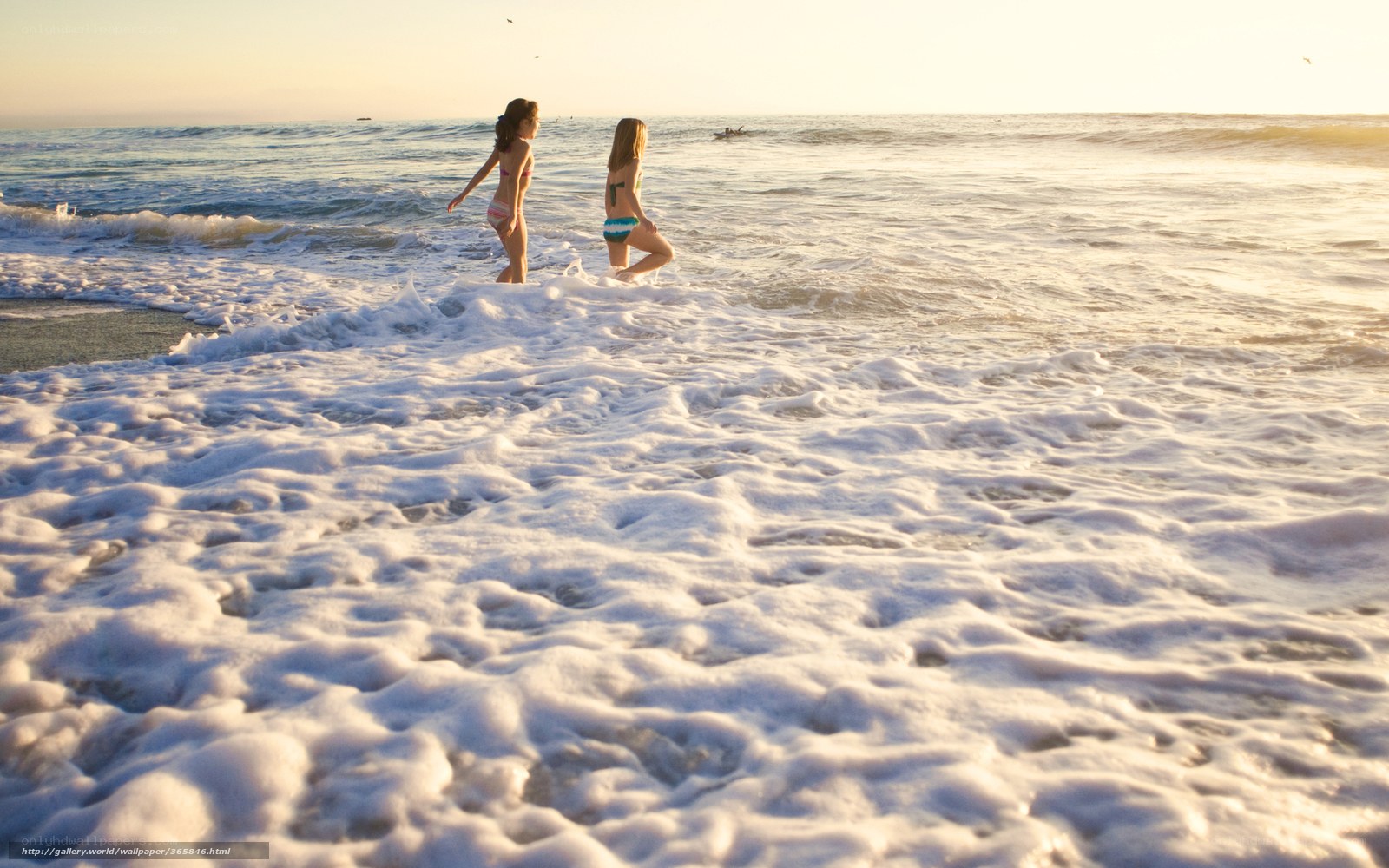 Girls at the beach at sunset