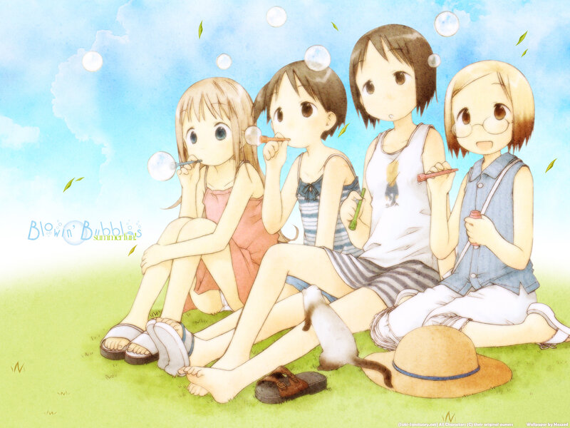 Girls blowing bubbles in summer