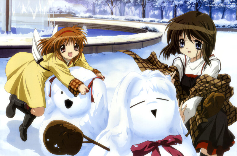 Girls building snowmen in winter