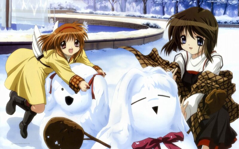 Girls building snowmen in winter