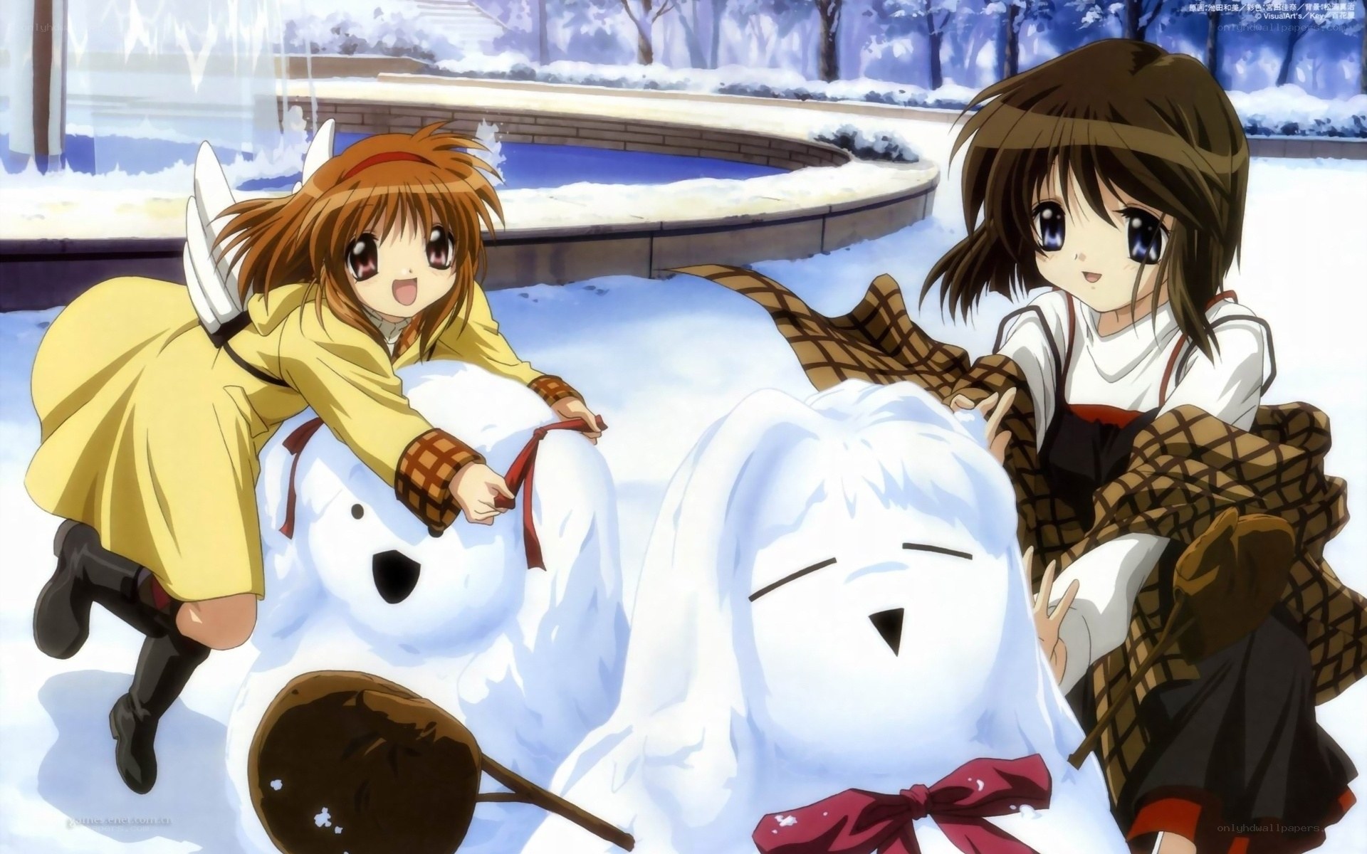 Girls building snowmen in winter