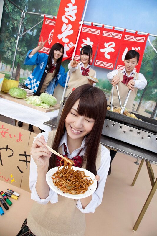 Girls enjoying noodles at a food stall