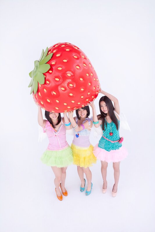 Girls holding giant strawberry