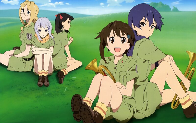 girls in green uniforms on grass