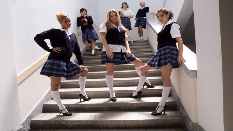 girls in school uniforms on stairs