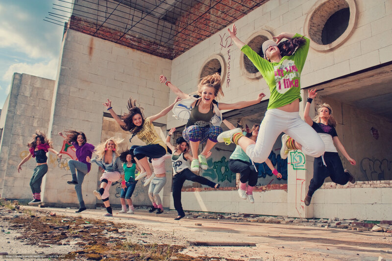 Girls jumping in abandoned building