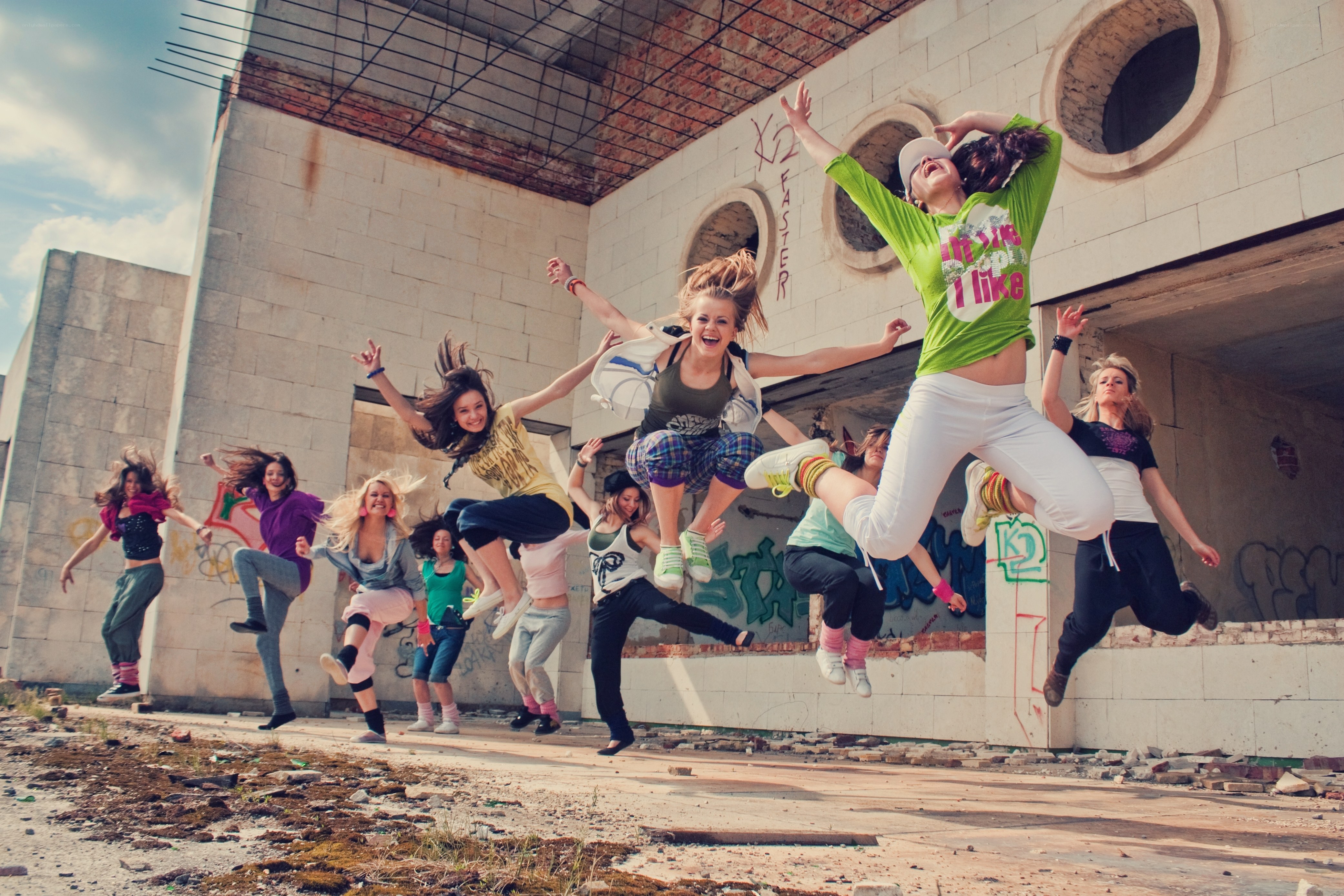 Girls jumping in an abandoned building