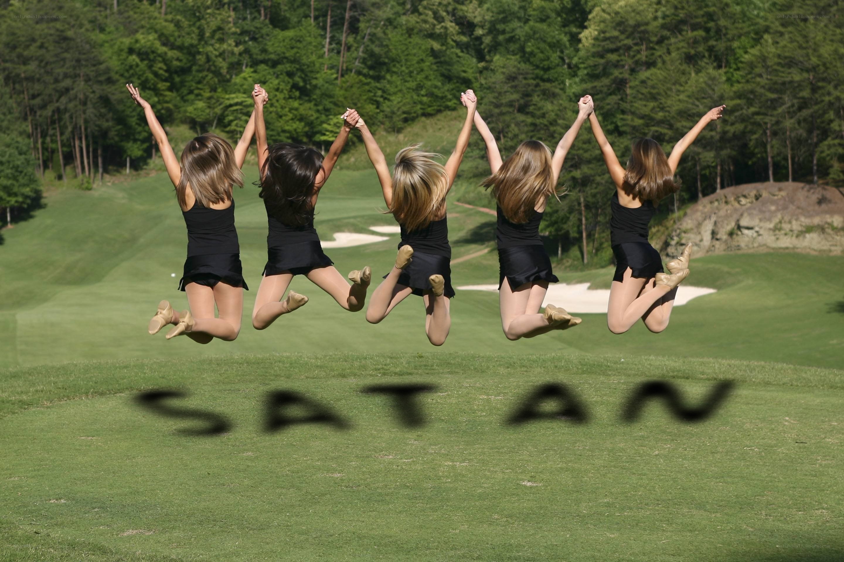 Girls jumping on a golf course